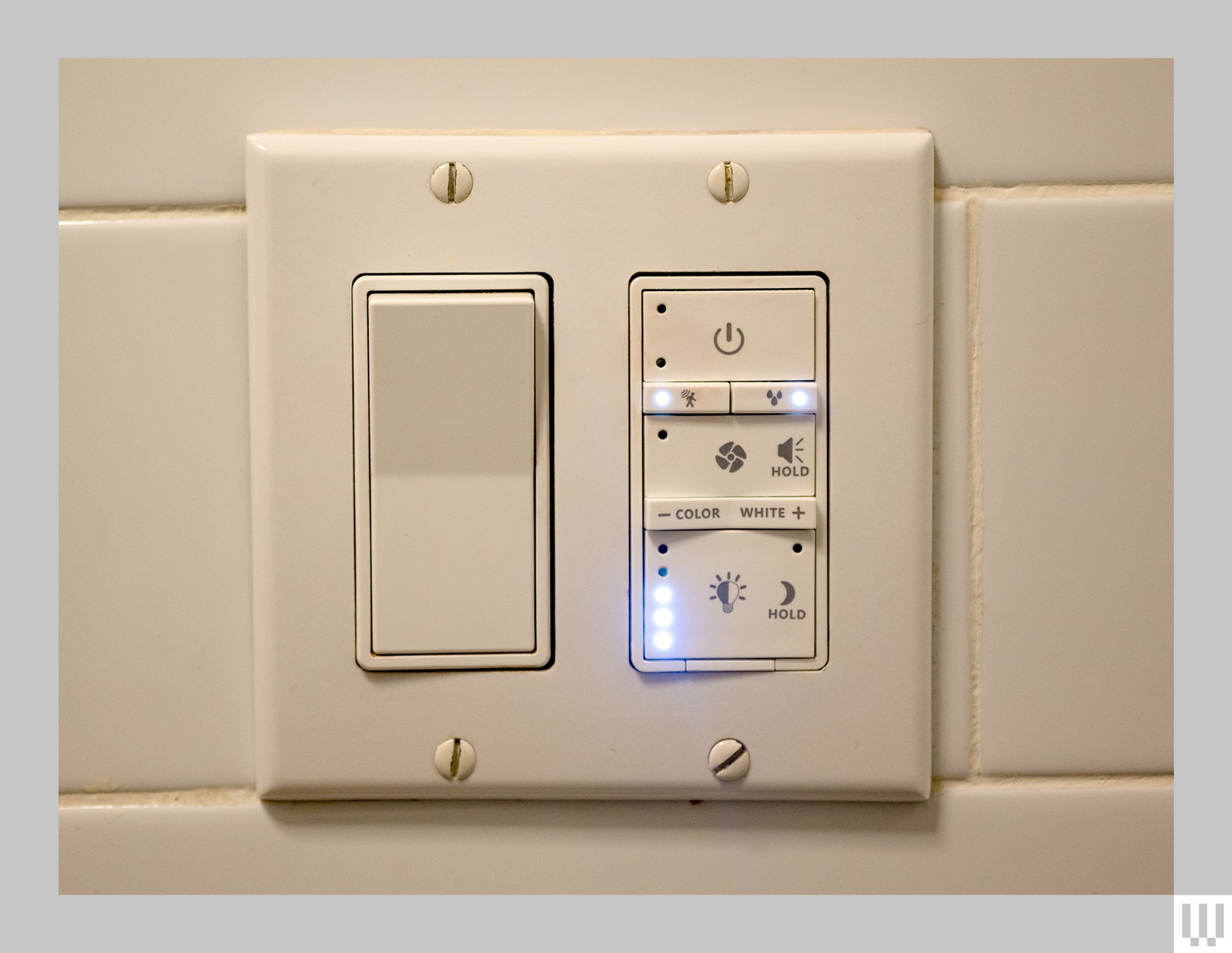 The switch of a commercial electric smart bathroom exhaust fan displaying light color, power and sound settings